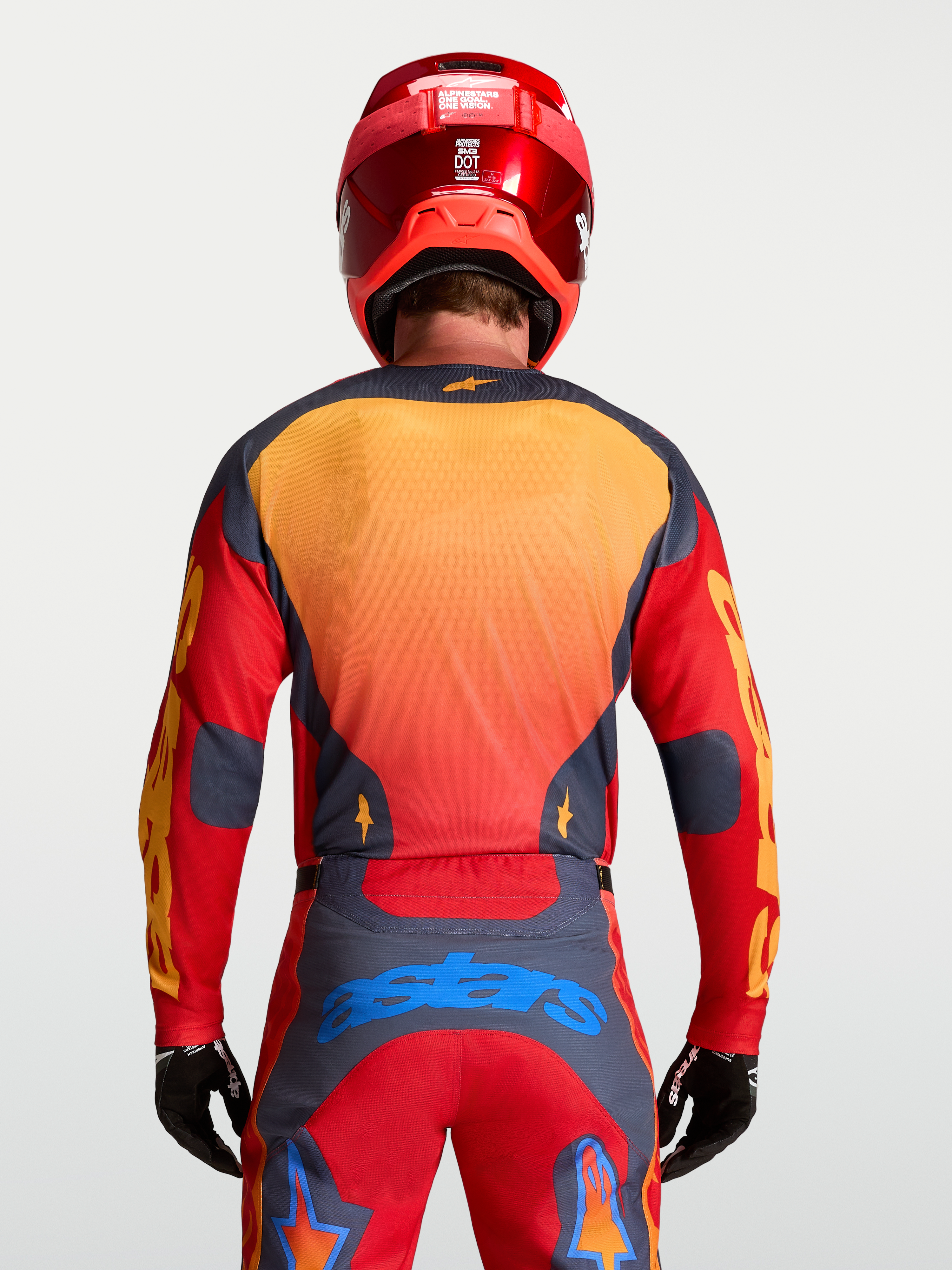 Alpinestars Racer Hunt Jersey, men's motocross racing gear in Fire Red and Graystone with yellow and blue accents, rear view on model.