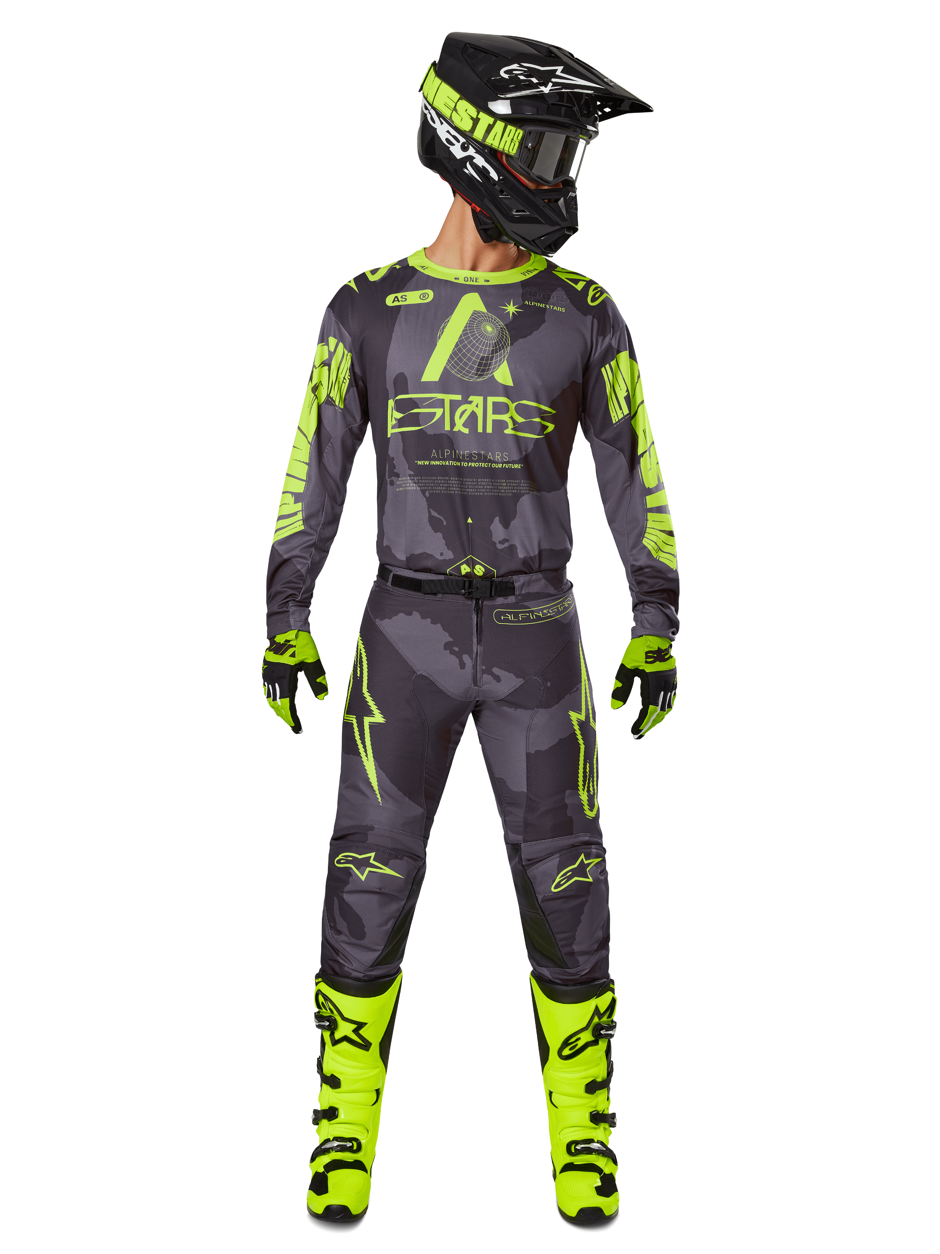 Motocross rider wearing complete racing gear, Alpinestars 2025 Racer Hollow Jersey and matching pants in Dark Camo Yellow Fluo, featuring bold fluorescent yellow graphics on a dark grey camouflage background, paired with matching gloves, bright yellow fluo boots, and a black helmet.