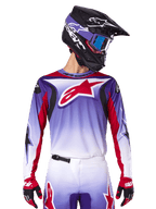 Alpinestars 2025 Fluid Wurx Jersey, Motocross Racing Jersey, Purple to White Gradient, Red star logo and accents, athletic fit, worn with matching pants, black helmet, and red gloves