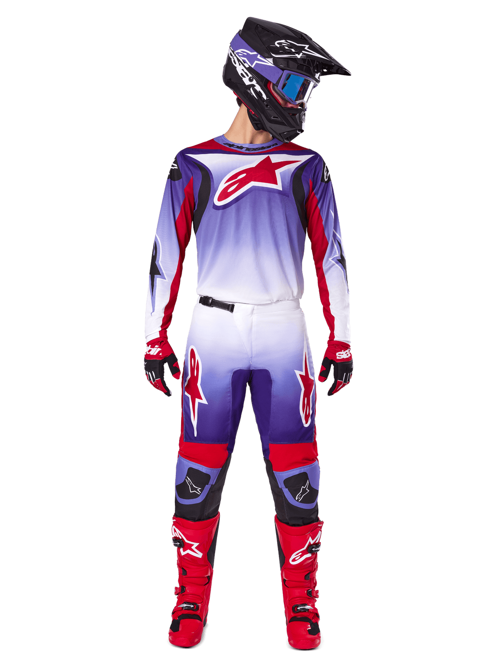Motocross rider wearing complete Alpinestars racing gear, 2025 Fluid Wurx Jersey in Purple Bright Red with white accents and large red star logo, matching pants, red boots, and black helmet with goggles, coordinated outfit for off-road racing