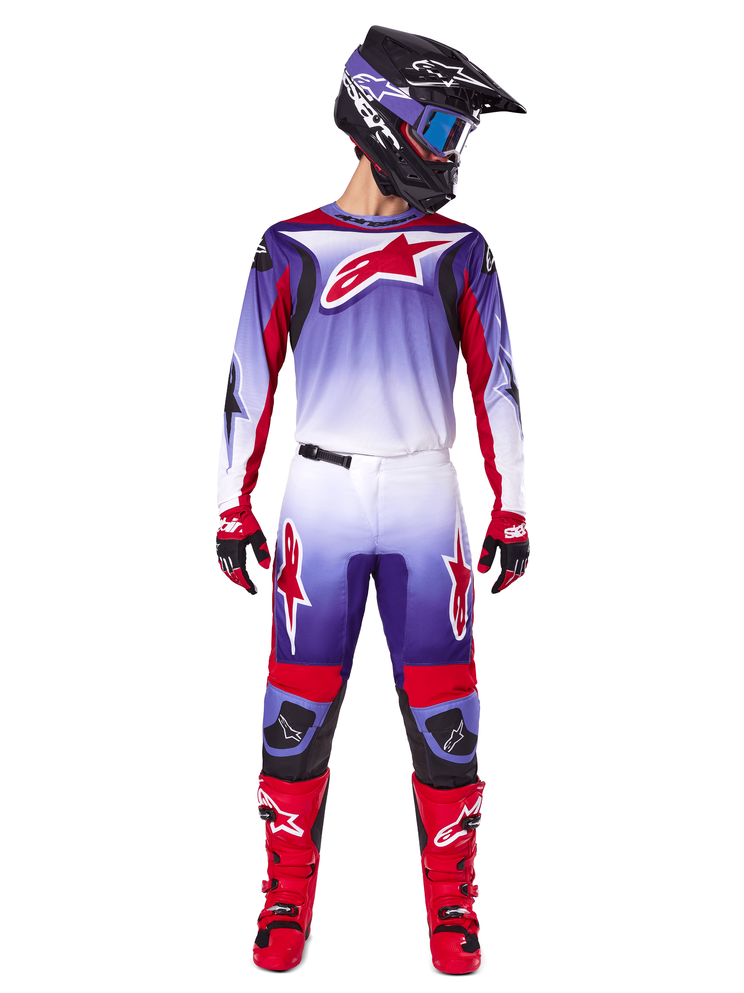 Motocross rider wearing complete Alpinestars racing gear, 2025 Fluid Wurx Jersey in Purple Bright Red with white accents and large red star logo, matching pants, red boots, and black helmet with goggles, coordinated outfit for off-road racing