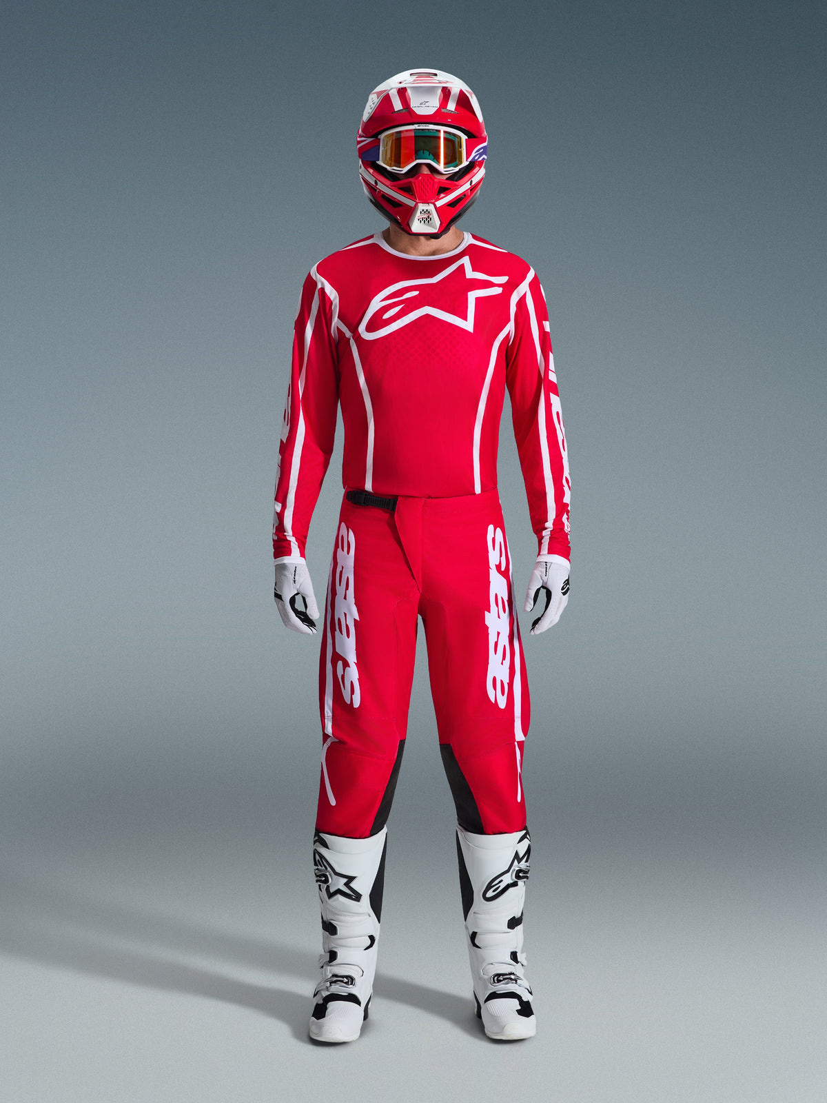 2026 Fluid Apex Gear Set, Motocross Outfit, Red and White, full racing kit including a red long-sleeve jersey with a white star logo, red pants with white branding and black inner knee panels, white boots with black accents, white gloves, and a matching red and white helmet with goggles, complete off-road racing ensemble