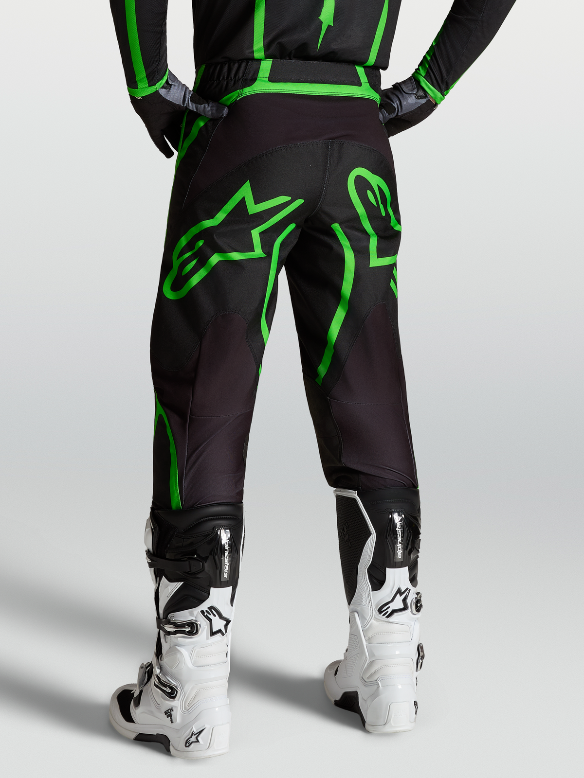 Alpinestars Fluid Apex V2 Pants, Men's Motocross and Off-Road Pants, Black and Green Fluo, Rear View on Model with White Boots.