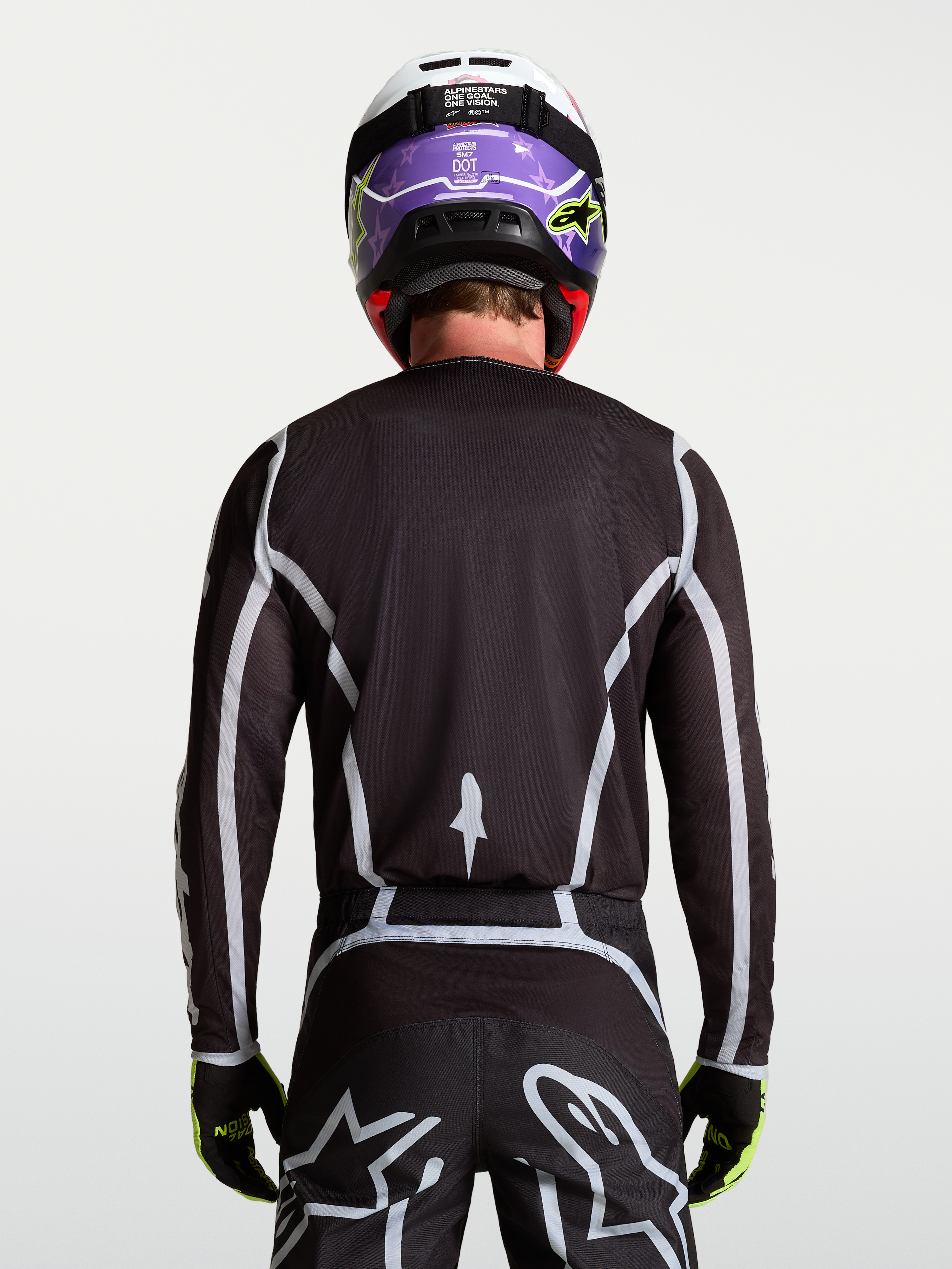Alpinestars Fluid Apex V2 trøje, herre-motocrosstrøje i sort og sølv, set bagfra med ergonomisk atletisk pasform.