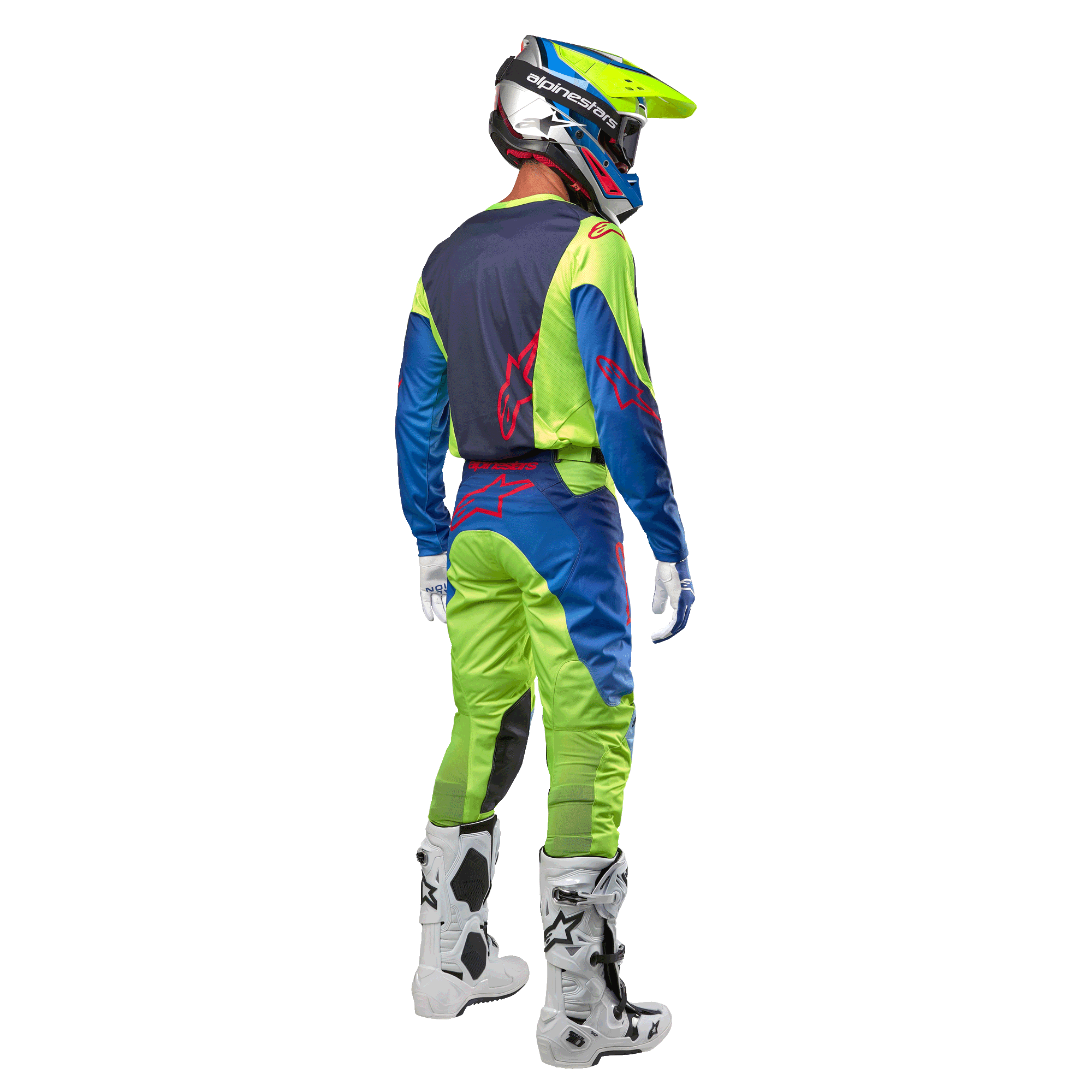 Alpinestars 2024 Racer Hoen Jersey i Yellow Fluo og Blue Night Navy, motocrosskører set bagfra med matchende bukser og hvide støvler, viser det bageste design med røde logoer, koordineret outfit til professionel terrænkørsel