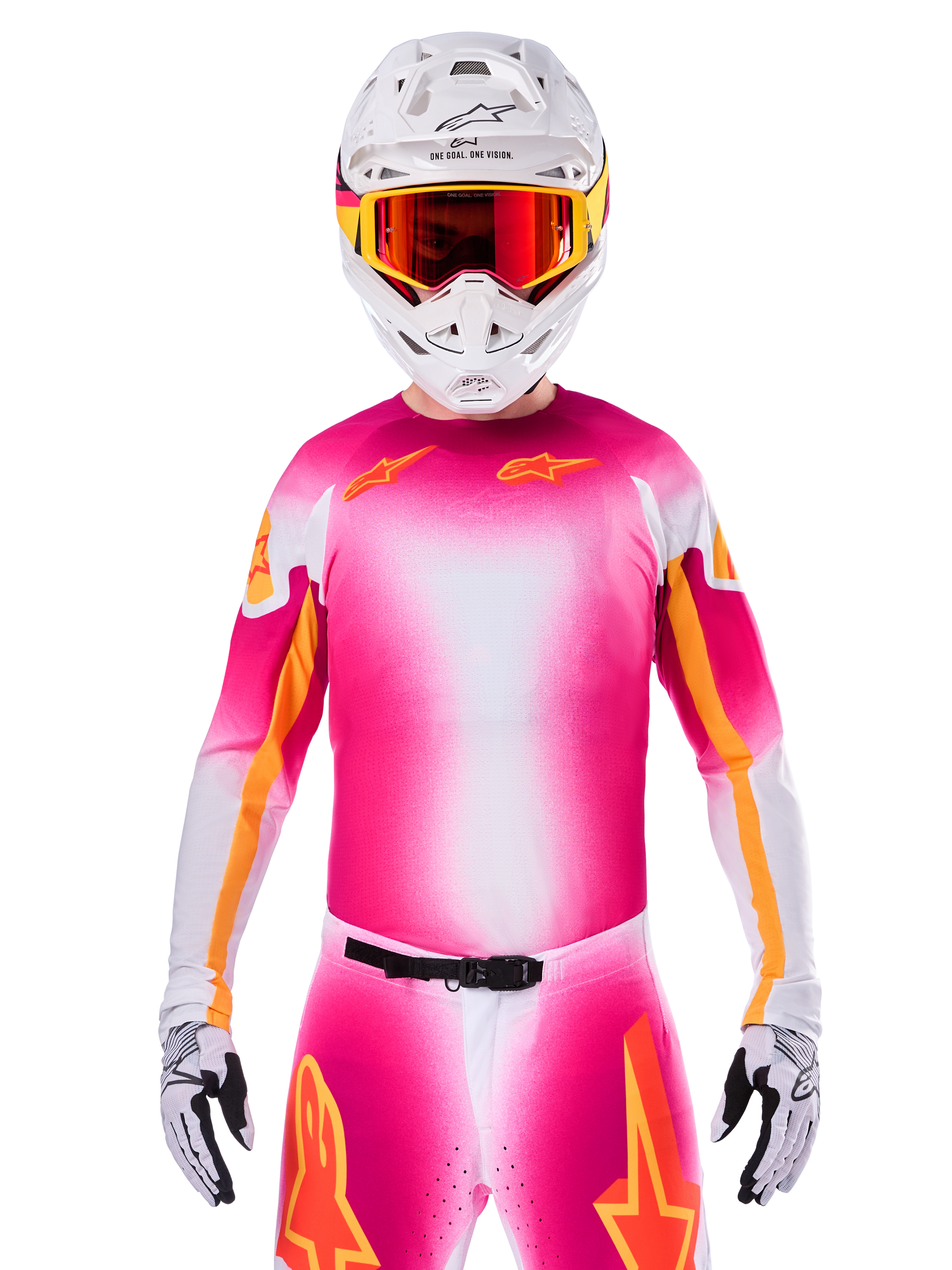 Motocross rider wearing the Alpinestars Limited Edition Supertech AFD MIG Jersey, Pink Fluo White gradient design with orange star logos, matching pants, white helmet, and red-tinted goggles, elite off-road racing apparel.