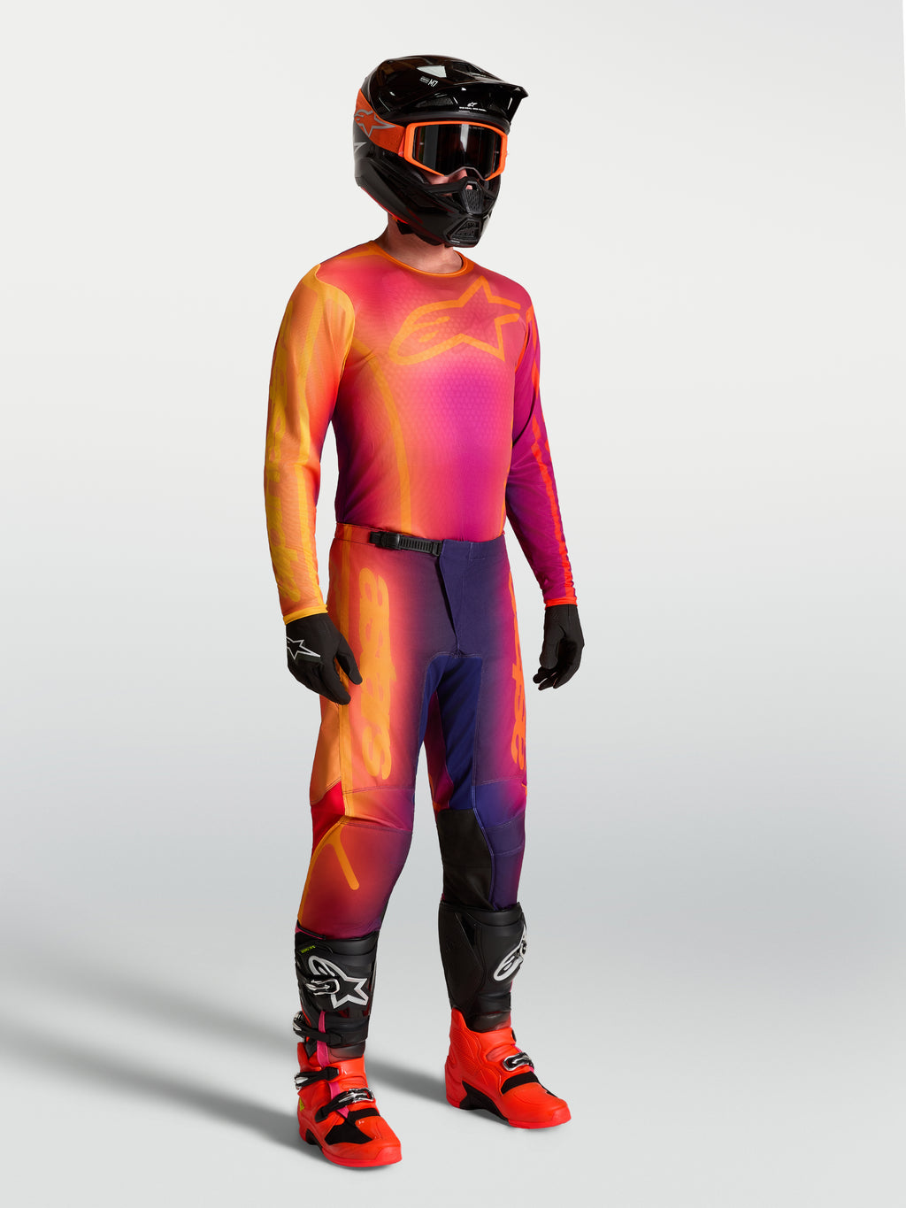 Alpinestars Fluid Kepler Jersey, purple and orange motocross jersey on-model with matching racing gear.