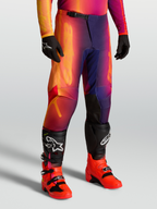 Alpinestars Fluid Kepler Pants for motocross, sport-fit off-road pants in purple and orange, featuring reinforced knees and ergonomic pre-curved design, worn with Tech series boots.