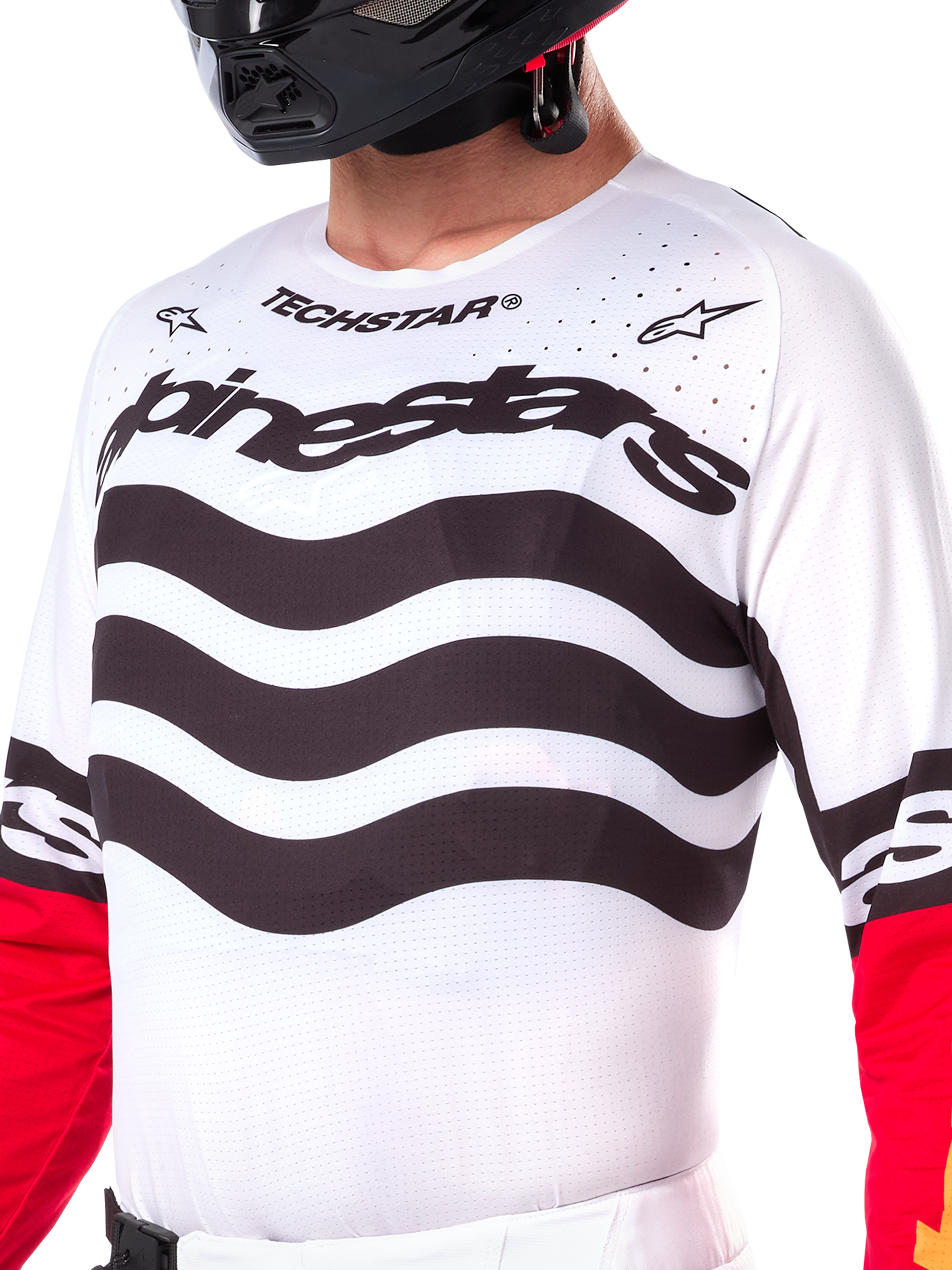 Alpinestars Limited Edition Techstar Deep Jersey, white motocross jersey with wavy black horizontal stripes and red sleeves, featuring Alpinestars and Techstar branding, small laser-cut perforations on the upper chest for ventilation, athletic off-road gear