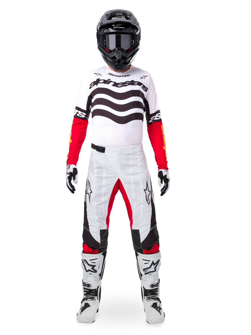 Motocross rider wearing the Alpinestars Limited Edition Techstar Deep Jersey in white, black, and red, featuring wavy chest graphics, paired with matching white and red pants, a black helmet, and white racing boots, full professional off-road gear setup.