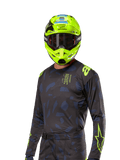 Alpinestars 2024 Techstar Rantera Jersey, motocross racingtrøje, sort og navy med abstrakte mønstre og neongule accenter, båret med matchende neongul hjelm, performance fit-design til off-road kørsel