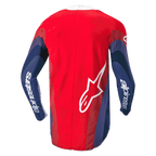 Alpinestars 2024 Techstar Pneuma trøje, motocross-trøje, rød, blå og hvid, set bagfra med bølgegrafik på ærmerne, hvidt Alpinestars-navnetræk på armene og Astar-logo nederst på ryggen, ergonomisk design til off-road kørsel