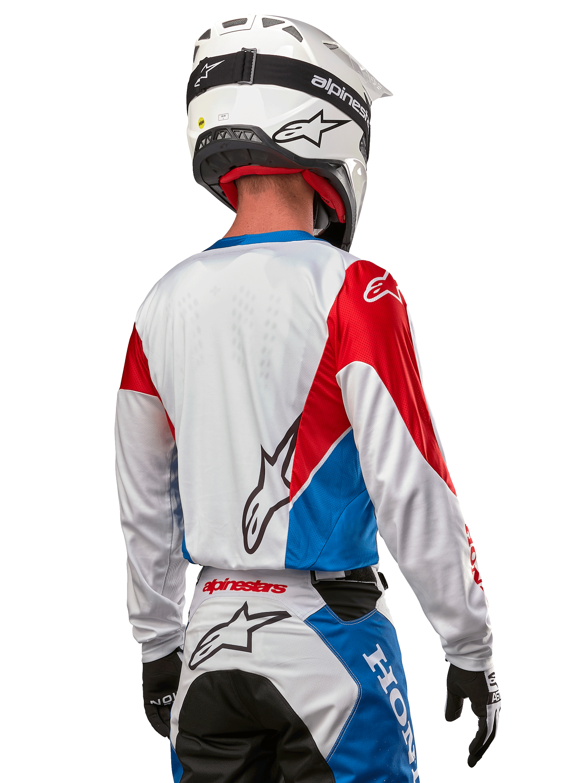 Alpinestars Honda Racer Iconic Jersey, motocross-trøje set bagfra, hvid med klare blå og røde paneler, tydeligt Alpinestars-logo på ryggen, hvid motocrosshjelm og matchende racerbukser, off-road racingudstyr