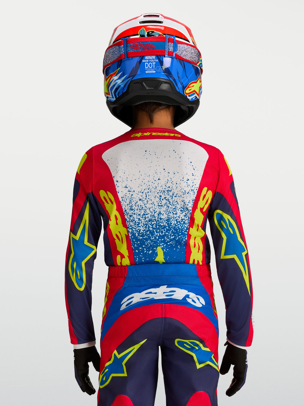 Alpinestars Fluid Drag trøje til ungdom, blå og rød teknisk motocrosstrøje set bagfra med ergonomisk pasform.