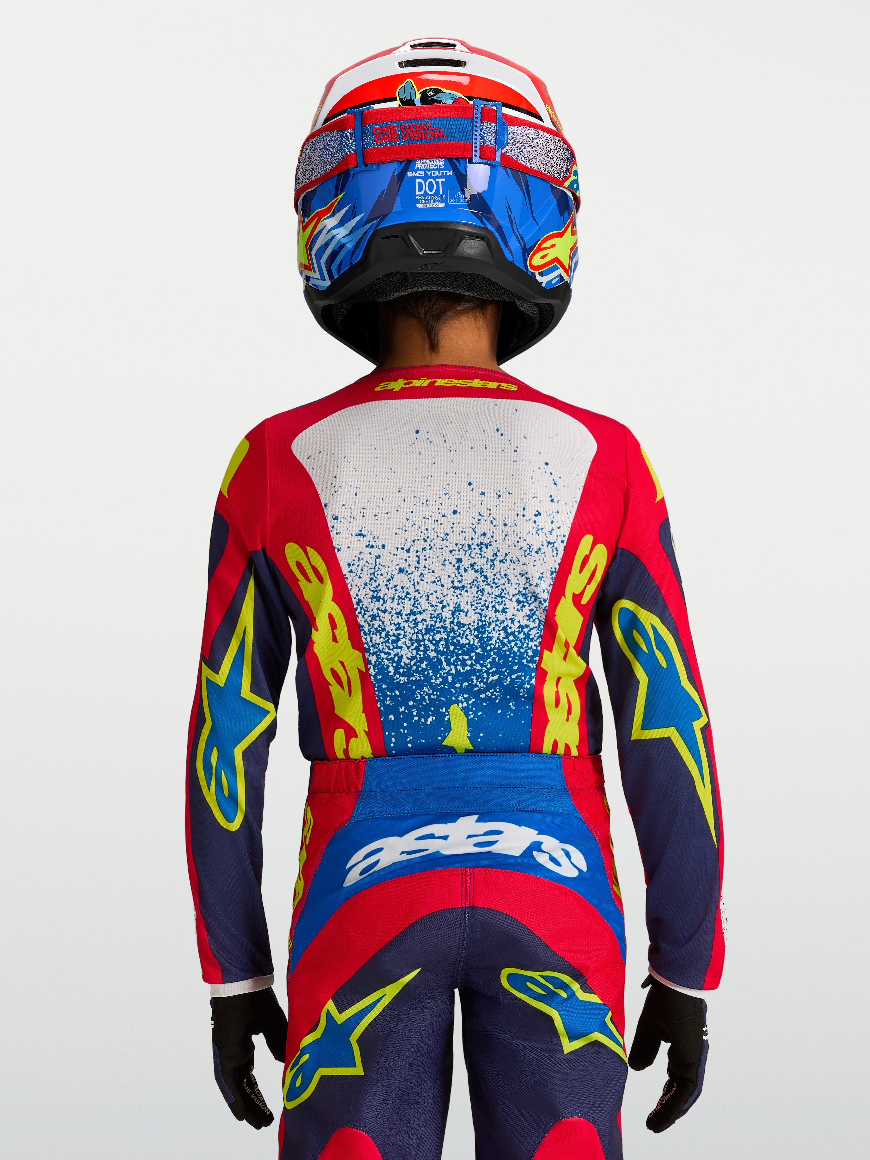 Alpinestars Fluid Drag trøje til ungdom, blå og rød teknisk motocrosstrøje set bagfra med ergonomisk pasform.