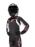 Alpinestars Youth 2024 Racer Lucent Jersey, motocross-trøje, sort, hvid og rød, båret af en ung rytter med en sort hjelm og matchende bukser, med røde stjernelogoer og hvide grafiske detaljer, højtydende off-road-beklædning til motocross-løb
