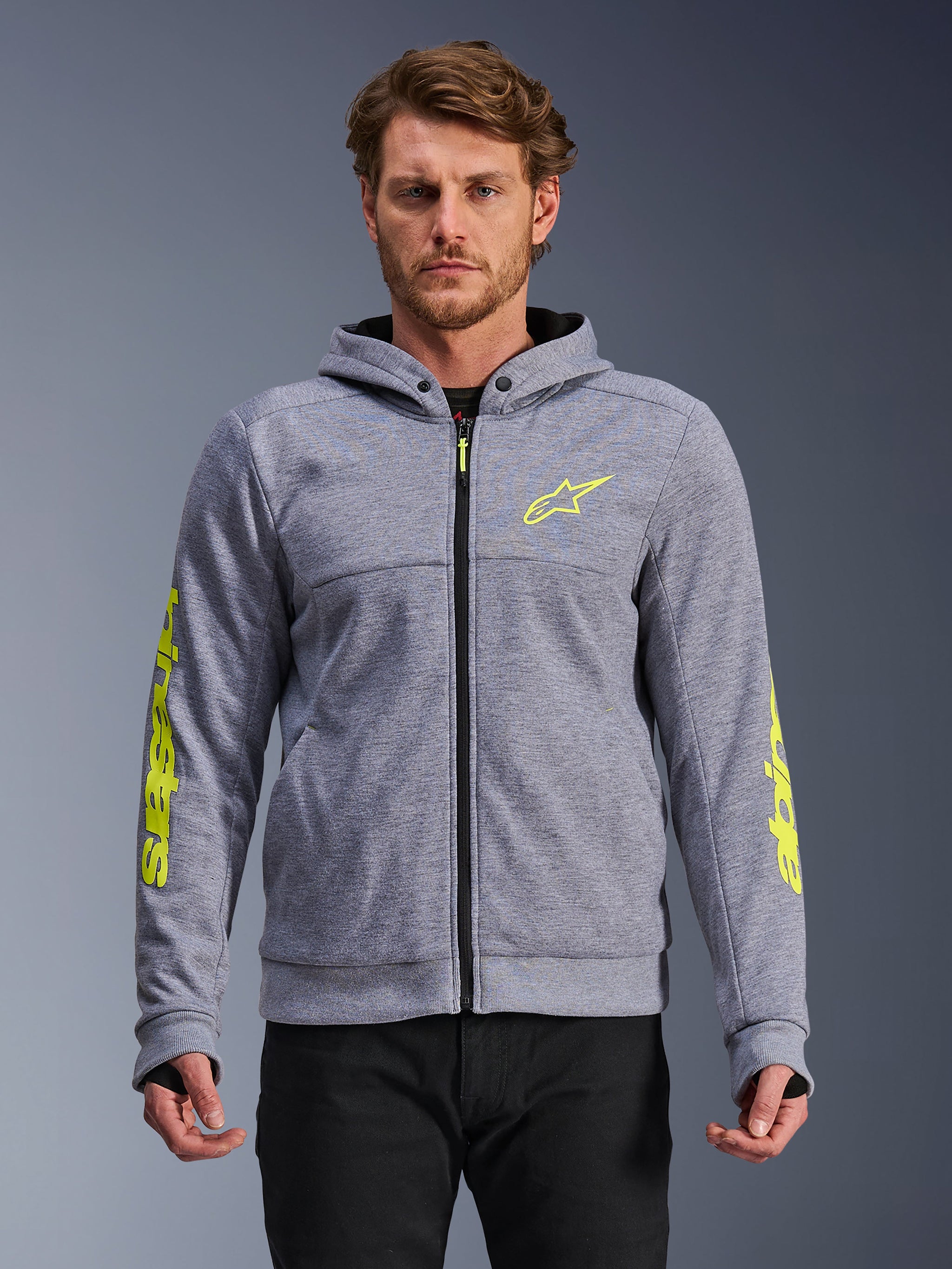 Alpinestars Chrome V2 Sport Hoodie, Gray Heather and Fluo Yellow, front view on model, tech fleece motorcycle hoodie with zippered front, neon yellow star logo on chest and branding on sleeves, casual urban riding gear