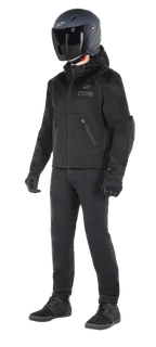 Alpinestars Moflow Air Tech Hoodie, Urban Motorcycle Hoodie, Black Black, worn by a rider with a matte black helmet, black gloves, and riding pants, featuring a full mesh construction for airflow, zippered pockets, and subtle chest logos, sleek casual design for warm weather street riding.