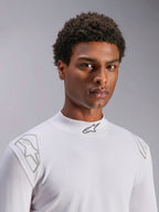 Alpinestars ZX Evo V3 langærmet top, hvidt baselayer til motorsport, båret af en mandlig model, høj hals med sort Alpinestars-logo, sølvfarvede grafiske print på skuldrene, letvægts flammehæmmende motorsportundertøj