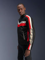 Male model wearing the Alpinestars T-Dyno Air Jacket in Black, Bright Red, and Ecru, vintage-inspired textile motorcycle jacket featuring 3D mesh panels, bold red and off-white stripes, and prominent Alpinestars branding on the sleeve.