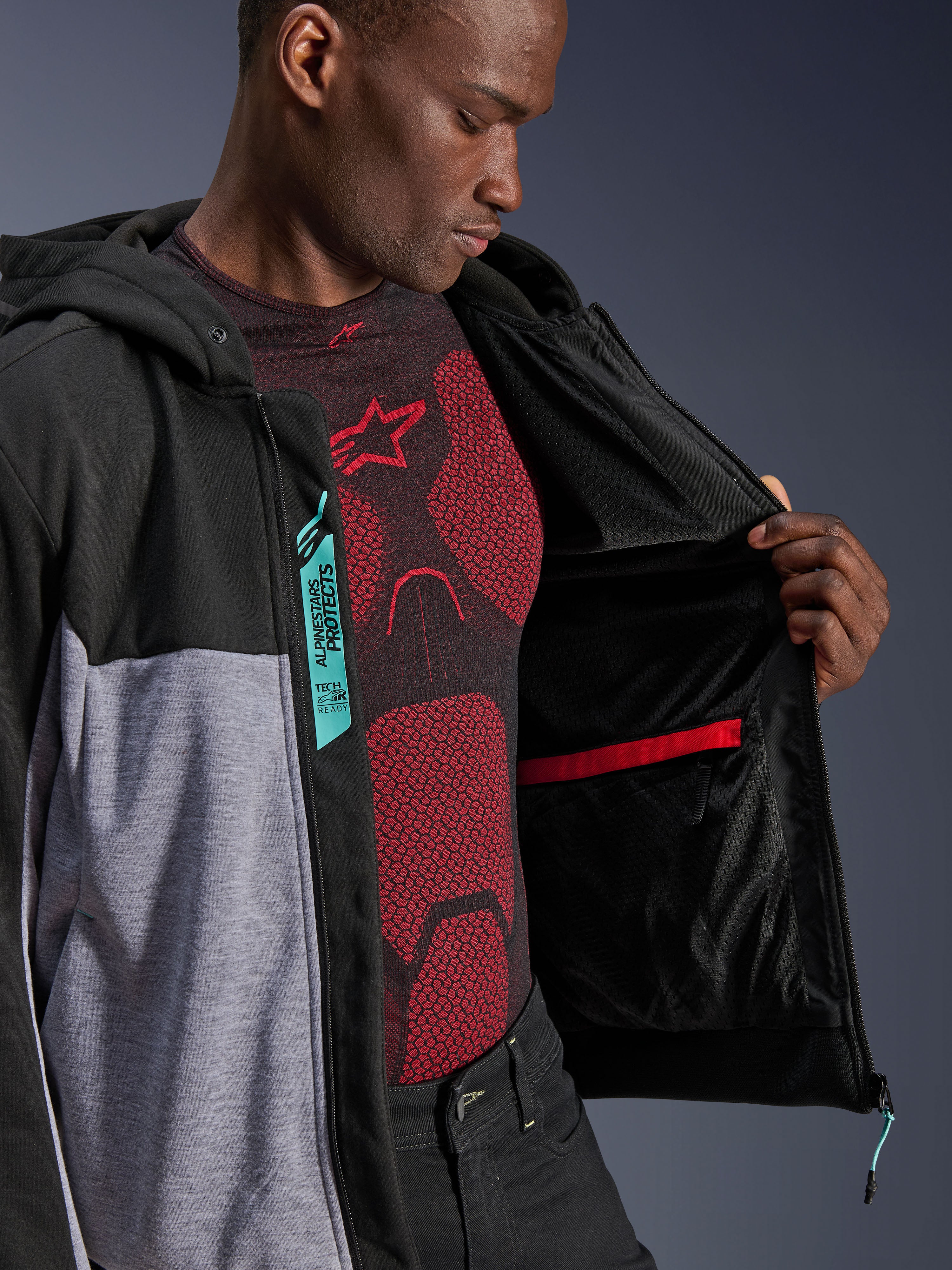 Alpinestars Chrome V2 Sport Hoodie, Motorcycle Jacket, Black Gray Heather and Turquoise, unzipped showing internal mesh lining and red-trimmed waterproof pocket, featuring turquoise Alpinestars Protects and Tech-Air Ready labels, urban riding gear