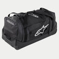 Alpinestars Komodo rejsetaske, stor taske til motocross-udstyr i sort og antracit med hvide logoer, udstyret med hjul og et teleskopisk håndtag, holdbar konstruktion til transport af racerudstyr