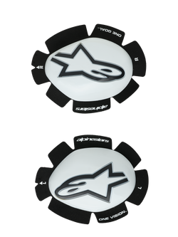 Alpinestars GP Plus Knee Sliders, White and Black, Motorcycle Racing Knee Protectors, pair showing left and right sliders with white plastic surfaces and black Astars logos, scalloped black Velcro backing featuring 'ONE GOAL' and 'ONE VISION' branding