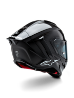 Alpinestars Supertech R10 Solid hjelm, motorcykelracerhjelm, sort carbon med mat og blank finish, trekvart visning bagfra viser kulfiberskal, aerodynamisk spoiler og Alpinestars-branding