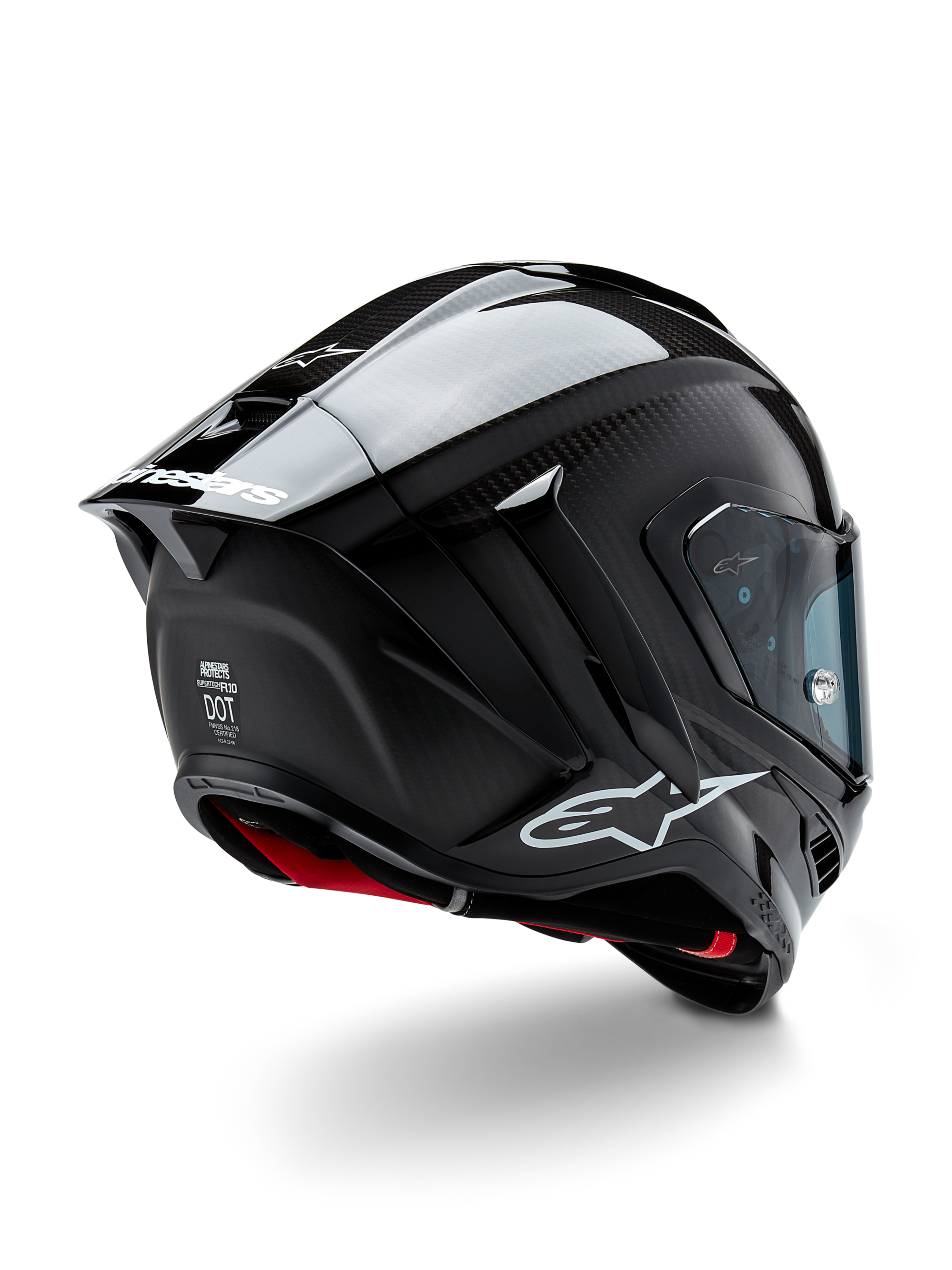 Alpinestars Supertech R10 Solid hjelm, motorcykelracerhjelm, sort carbon med mat og blank finish, trekvart visning bagfra viser kulfiberskal, aerodynamisk spoiler og Alpinestars-branding