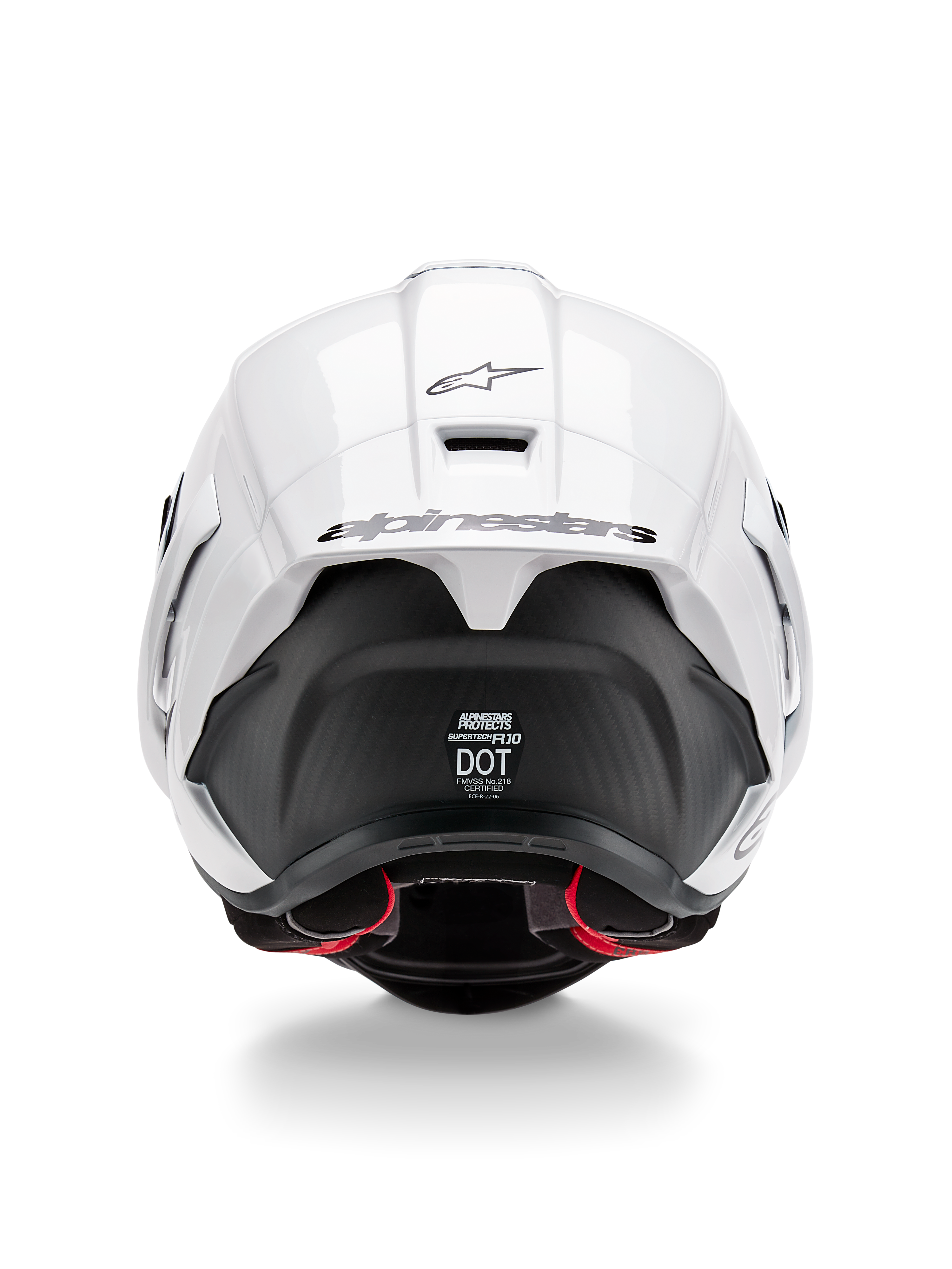 Alpinestars Supertech R10 Solid hjelm, set bagfra, hvid blank top med mat sort nedre del, aerodynamisk spoiler med sort Alpinestars-logo, synlig kulfiberstruktur og sikkerhedscertificeringsmærkater