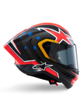 Alpinestars Supertech R10 Miller Limited Edition hjelm, full-face racerhjelm, mat carbon med rød, hvid og blå grafik, blå stjerne-detaljer og gul kant ved visir, aerodynamisk profil med mørkt røgfarvet visir, højtydende sikkerhedsudstyr til motorcykel
