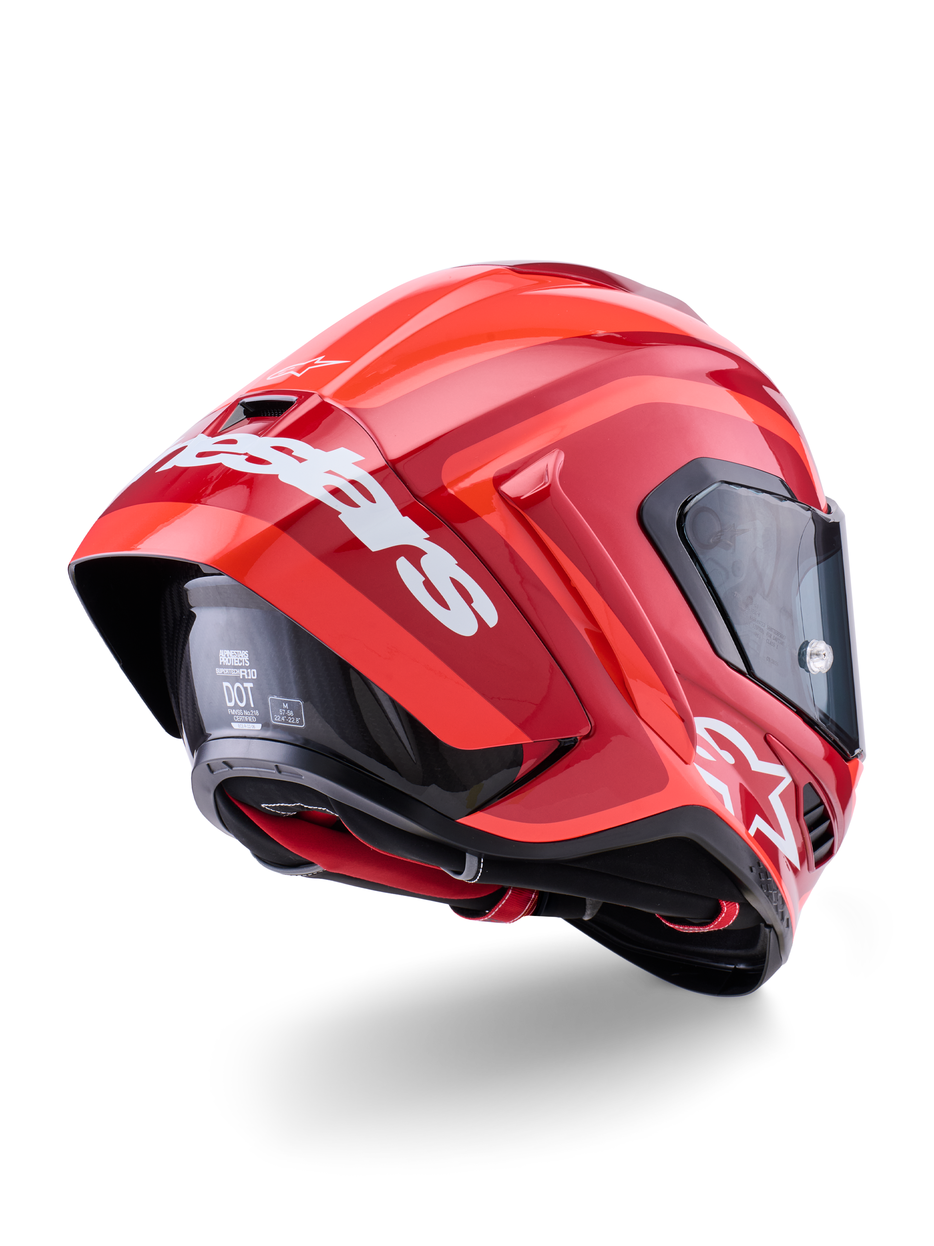 Alpinestars Supertech R10 Arius-hjelm, blank rød med hvid branding, set skråt bagfra, der viser den aerodynamiske spoiler, skalkonstruktion i kulfiber og en slank racerprofil med mørkt visir