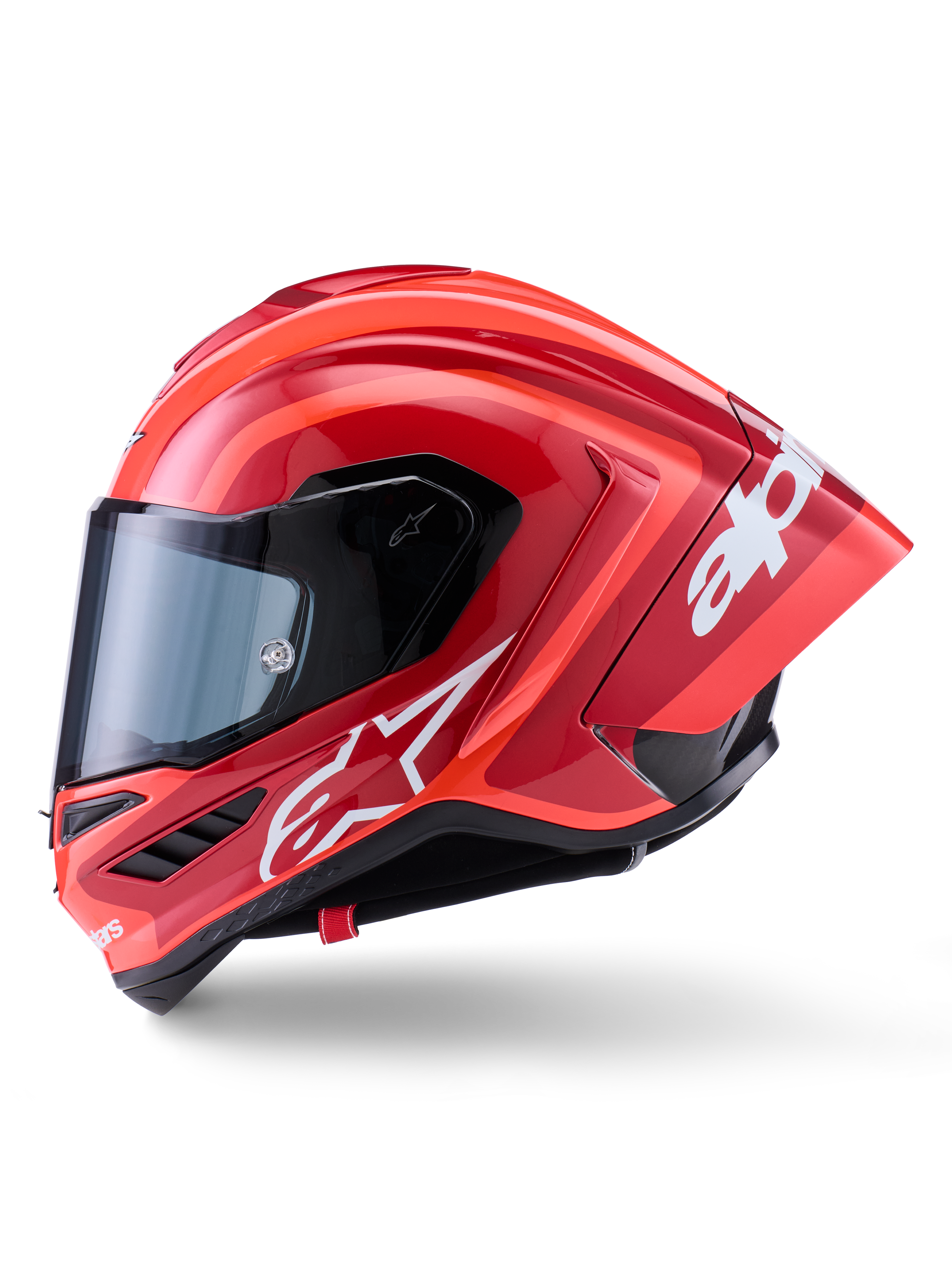 Alpinestars Supertech R10 Arius hjelm, full-face racerhjelm, blank rød med hvid logografik, sideprofil der fremhæver den aerodynamiske spoiler og det klare visir, carbon-kompositskal til professionel motorsport