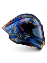 Supertech R10 Martinator Thai-hjelm i blank blå kulfiber med detaljeret guld mandalagrafik og en aerodynamisk racingprofil.