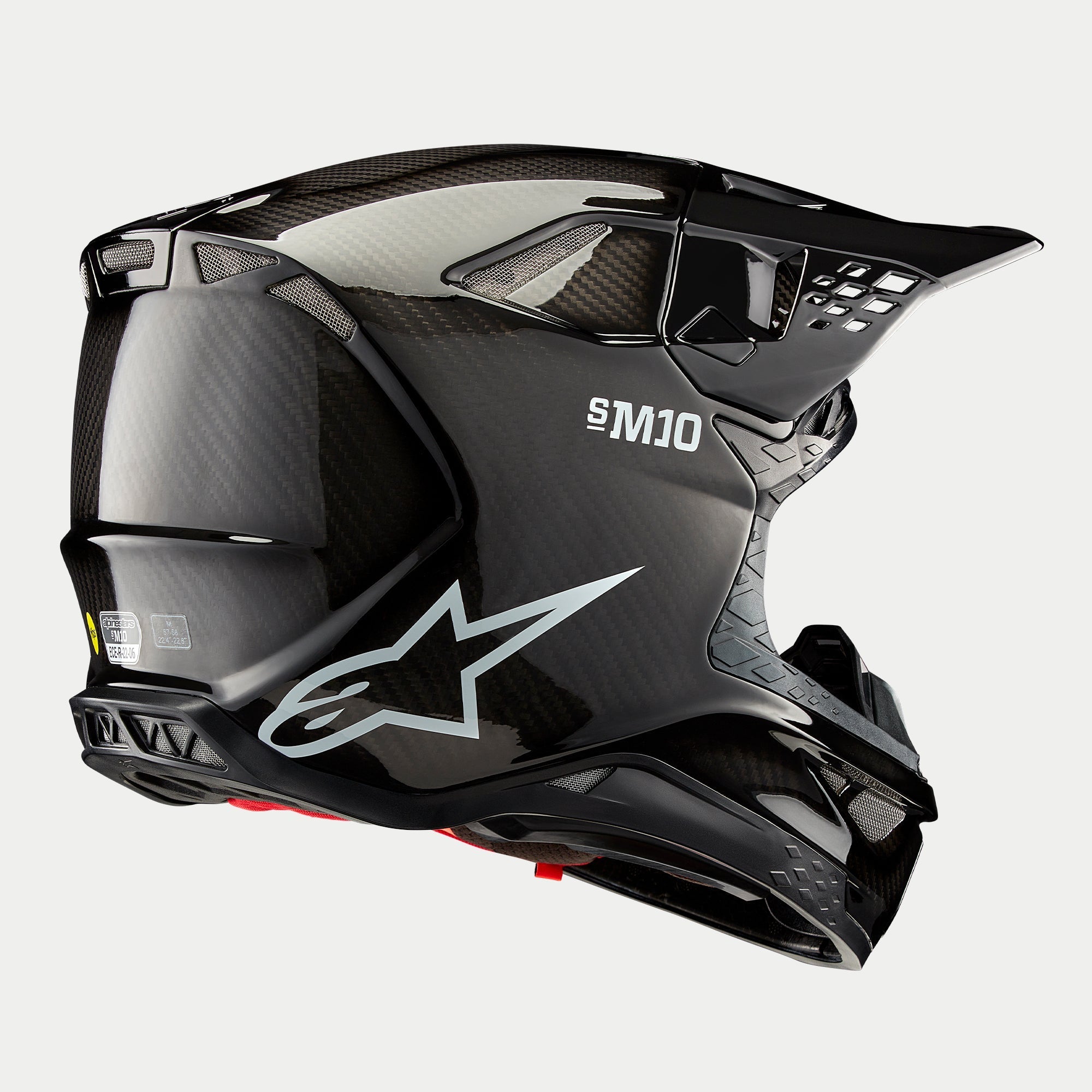 Alpinestars Supertech M10 Solid hjelm, motocross-hjelm, sort blank carbon-finish, med hvidt Astars-logo og S-M10-branding, aerodynamisk skal med synlig carbon-vævning og flere ventilationsporte