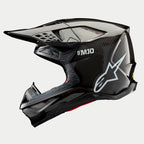 Alpinestars Supertech M10 Solid hjelm, motocrosshjelm, sort blank carbon, sideprofil med synlig kulfibervævning, hvidt SM10-logo og Alpinestars-logo, strømlinet aerodynamisk design med mesh-dækkede ventilationsåbninger
