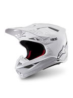 Alpinestars Supertech M10 Solid-hjelm, ECE 22.06-certificeret motocrosshjelm i blank hvid med sort og rød indvendig polstring, skyggevisir og flere ventilationsporte, vist i trekvart profil