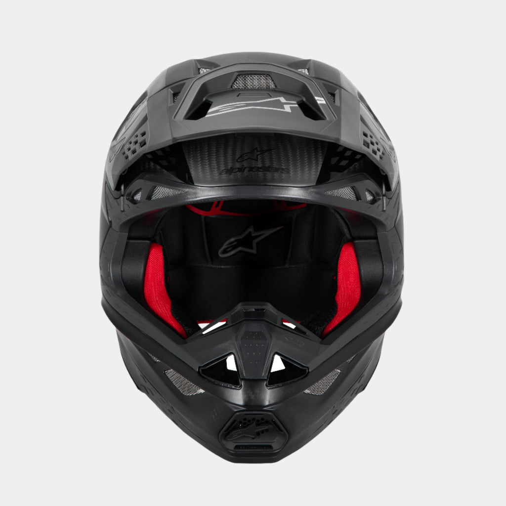 Alpinestars Supertech M10 Fame ECE 22.06 hjelm, motocrosshjelm, mat og blank sort carbon, set forfra med synlig rød indvendig polstring, aerodynamisk kulfiberskal, ventileret design til off-road racing