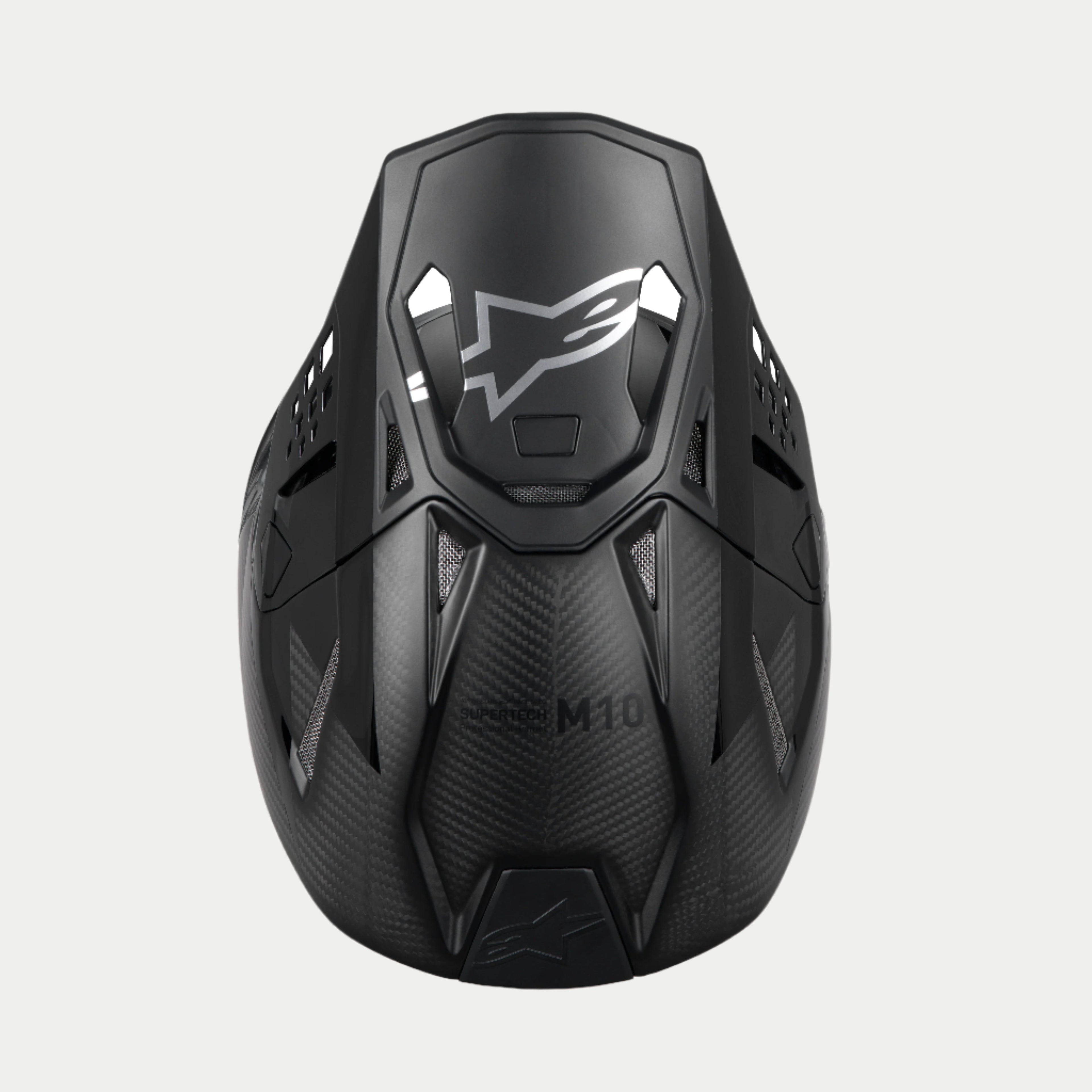 Alpinestars Supertech M10 Fame ECE 22.06 hjelm, motocrosshjelm, sort carbon mat og blank, top-down visning der fremhæver kulfibervævningen, aerodynamisk visir med sølvfarvet Alpinestars-logo og flere ventilationsåbninger til off-road racing.