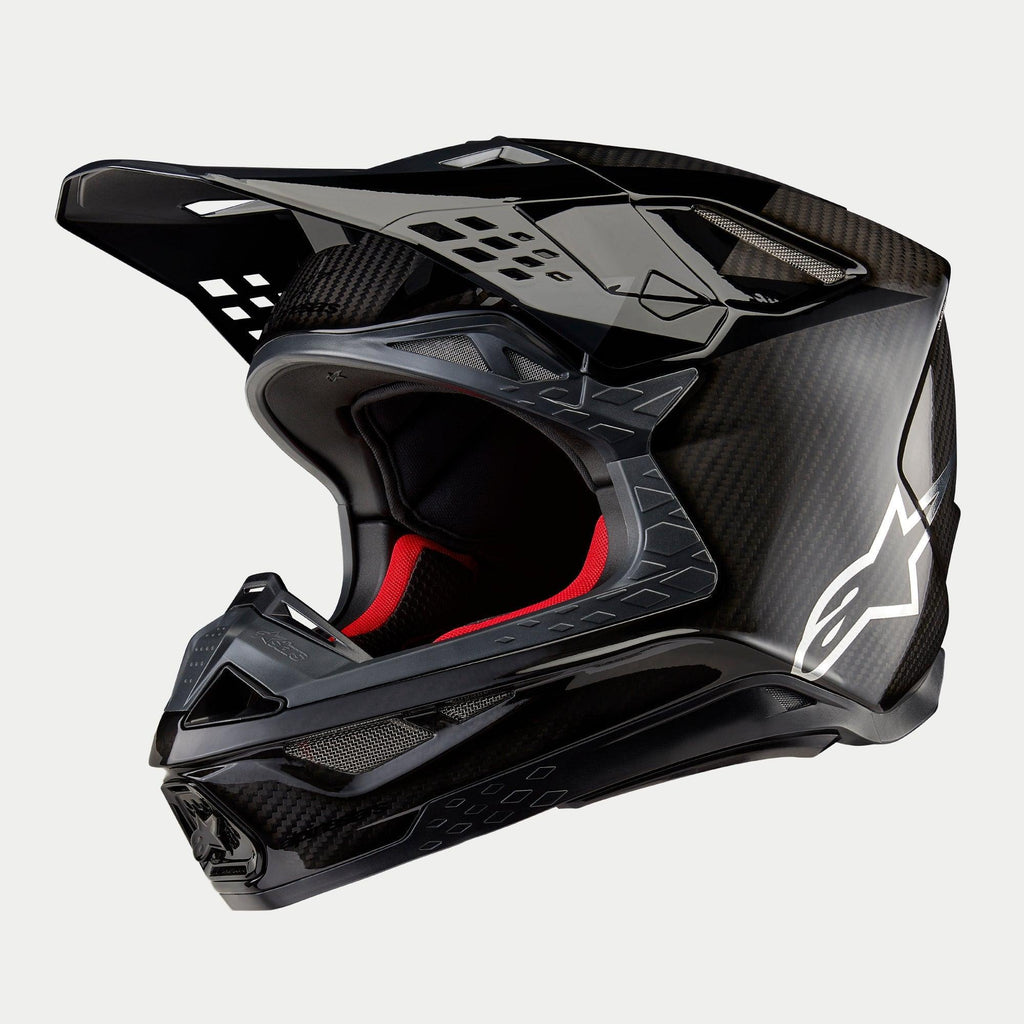 Alpinestars Supertech M10 Fame ECE 22.06 hjelm, motocrosshjelm, sort carbon i mat og blank finish, med synlig kulfibervævning, hvidt Astar-logo på siden og rød indvendig polstring, aerodynamisk off-road design