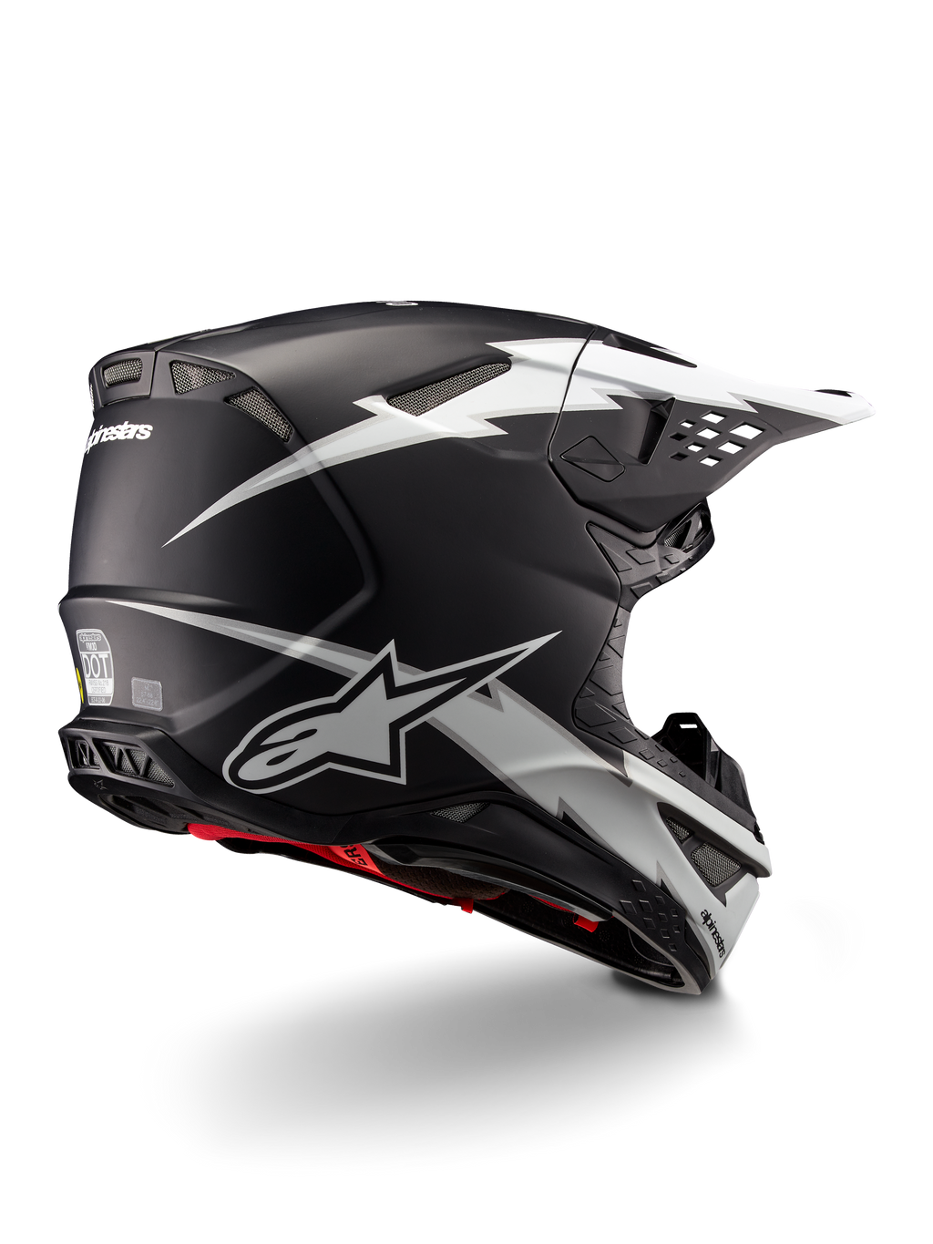 Alpinestars Supertech M10 Ampress hjelm, motocrosshjelm, sort og hvid mat, med markante hvide lyngrafikker på en matsort skal, set trekvart bagfra, der viser Alpinestars-branding og ventilationsåbninger