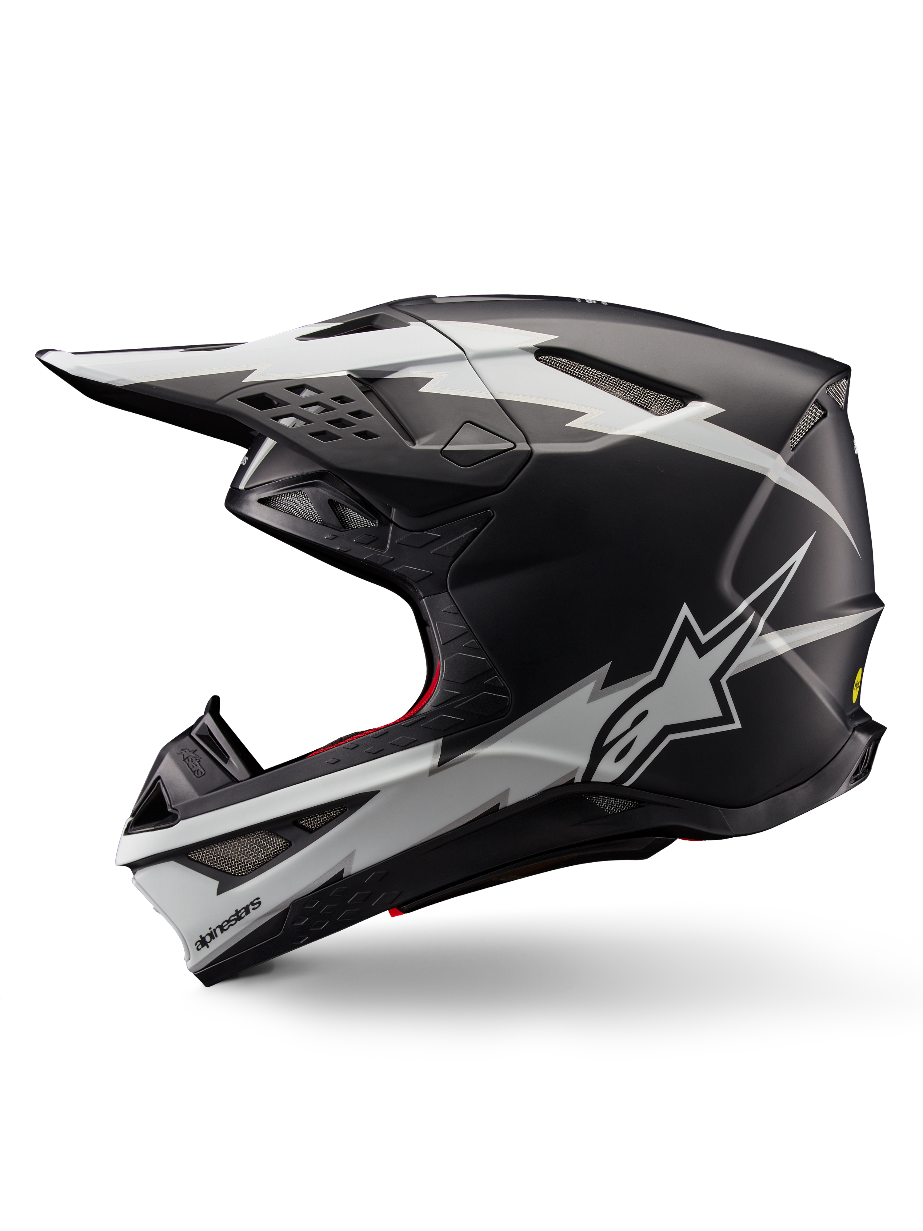 Alpinestars Supertech M10 Ampress hjelm, motocross-hjelm, matsort og hvid, profilvisning med markant hvid lyn-grafik, aerodynamisk skal med synlige ventilationsåbninger og visir, avanceret off-road beskyttelse
