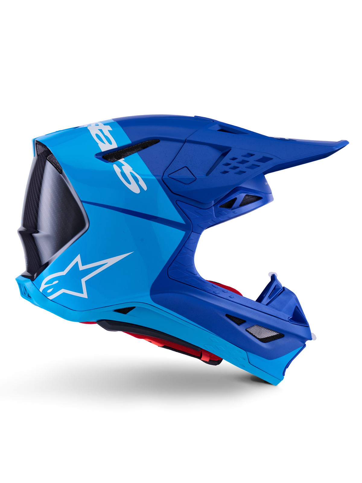 Alpinestars Supertech M10 Flood-hjelm, motocross-hjelm, metallic og mellemblå med sorte carbon-detaljer, sideprofil, hvidt logo, aerodynamisk design med ventilationsporte, kulfibertekstur, professionel off-road racingbeskyttelse