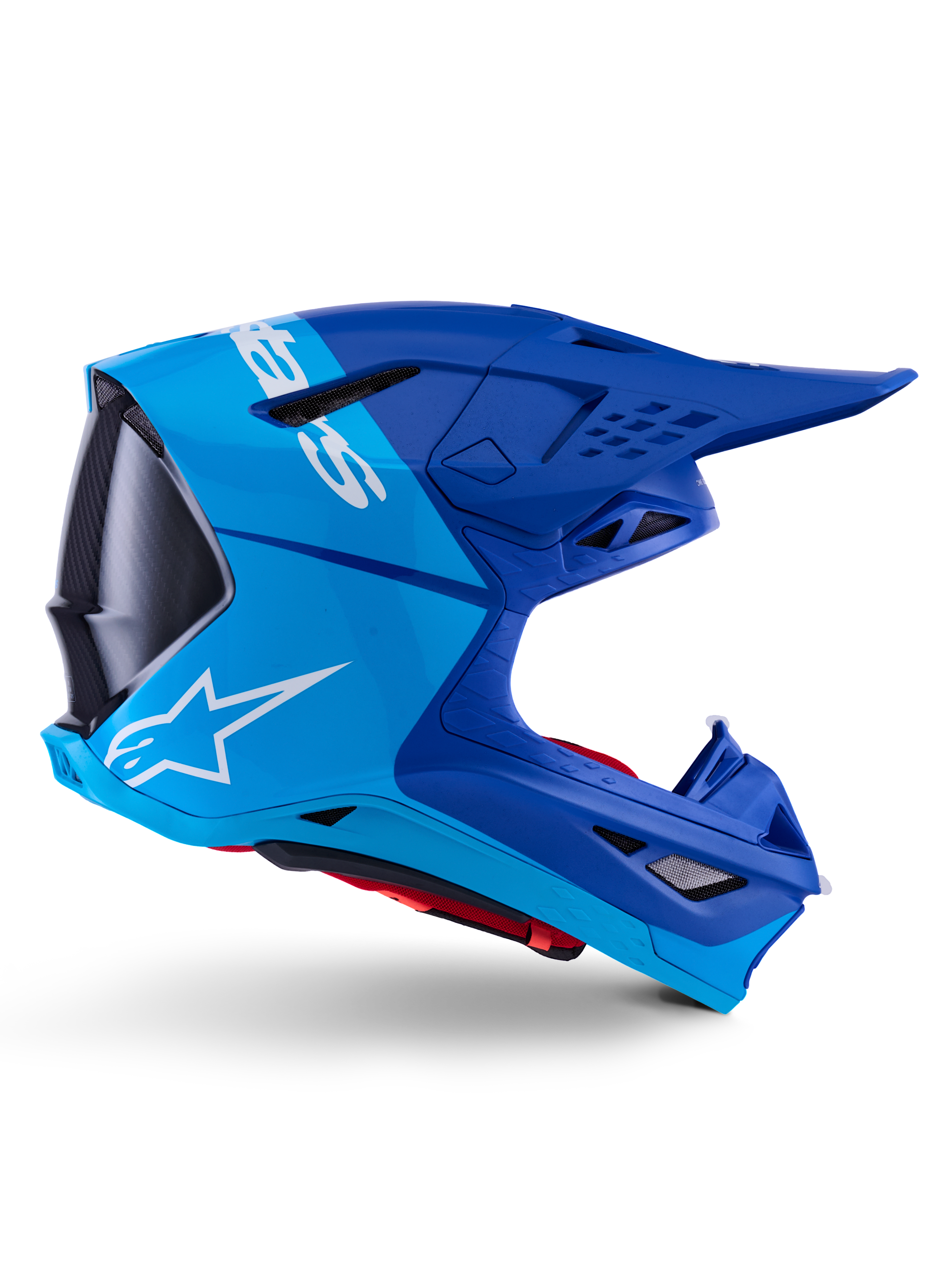 Alpinestars Supertech M10 Flood-hjelm, motocross-hjelm, metallic og mellemblå med sorte carbon-detaljer, sideprofil, hvidt logo, aerodynamisk design med ventilationsporte, kulfibertekstur, professionel off-road racingbeskyttelse