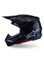 Alpinestars S-M7 Solid hjelm, blanksort motocrosshjelm, sideprofil der viser hvidt Alpinestars-logo, aerodynamisk skal med ventilationsnet og rød indvendig polstring, avanceret off-road beskyttelse