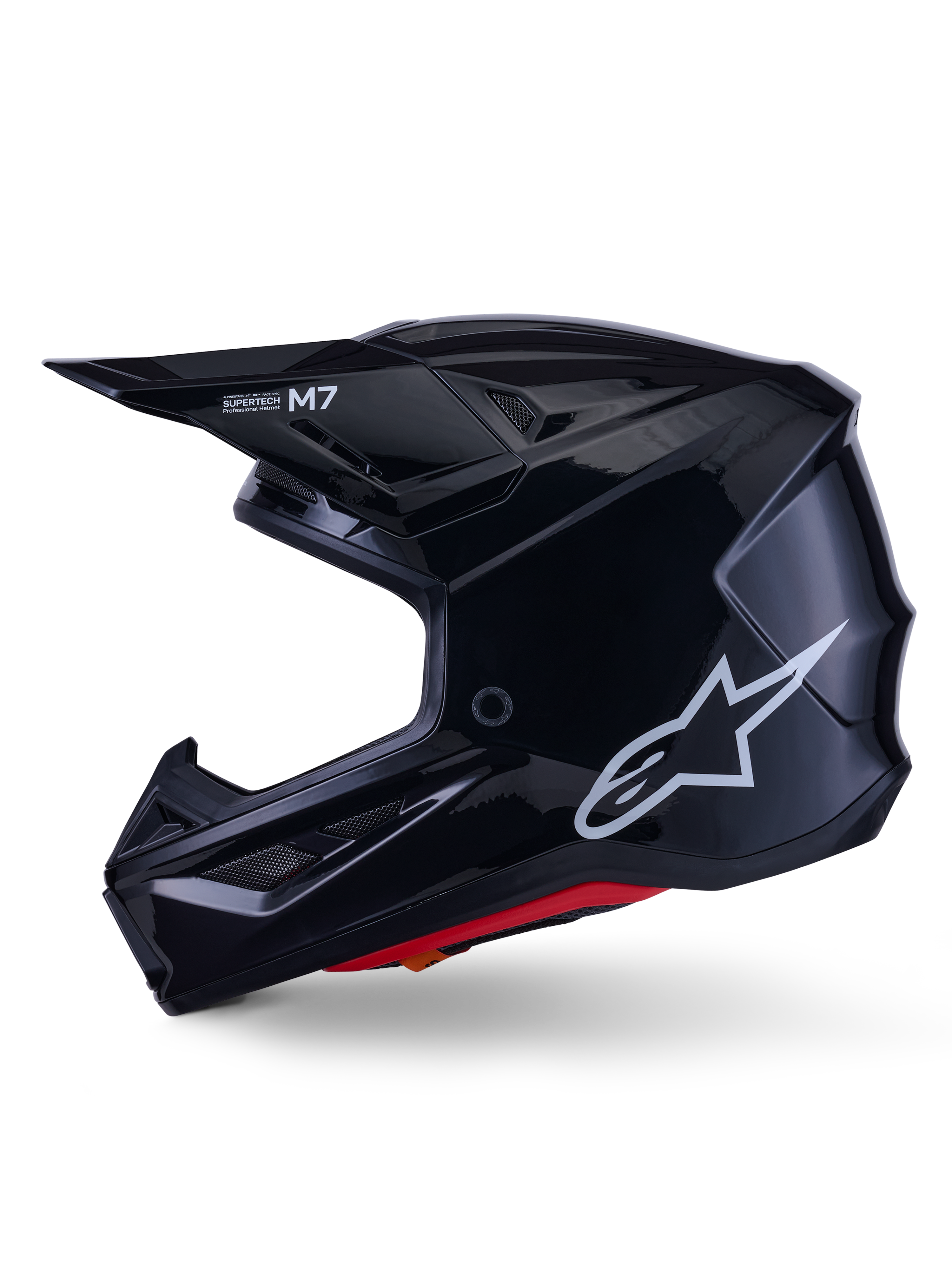 Alpinestars S-M7 Solid hjelm, blanksort motocrosshjelm, sideprofil der viser hvidt Alpinestars-logo, aerodynamisk skal med ventilationsnet og rød indvendig polstring, avanceret off-road beskyttelse