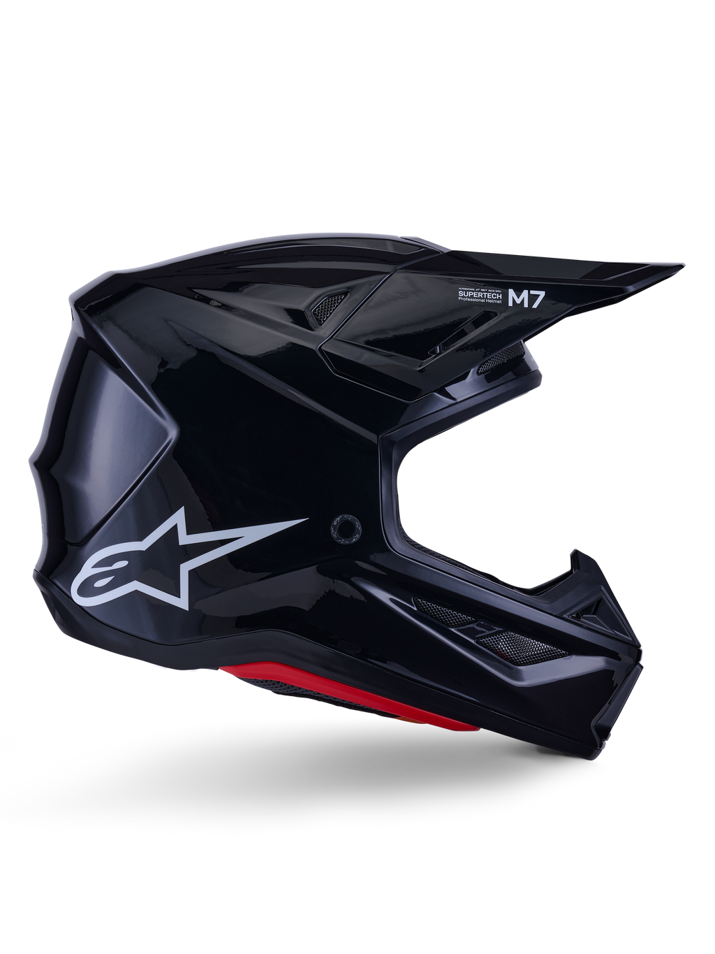 Alpinestars S-M7 Solid hjelm, motocross racinghjelm, blank sort med hvidt stjerne-logo og røde detaljer, sideprofil med aerodynamisk design, kantede ventilationsåbninger og Supertech M7-branding på visiret.