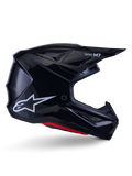 Alpinestars S-M7 Solid hjelm, motocross racinghjelm, blank sort med hvidt stjerne-logo og røde detaljer, sideprofil med aerodynamisk design, kantede ventilationsåbninger og Supertech M7-branding på visiret.