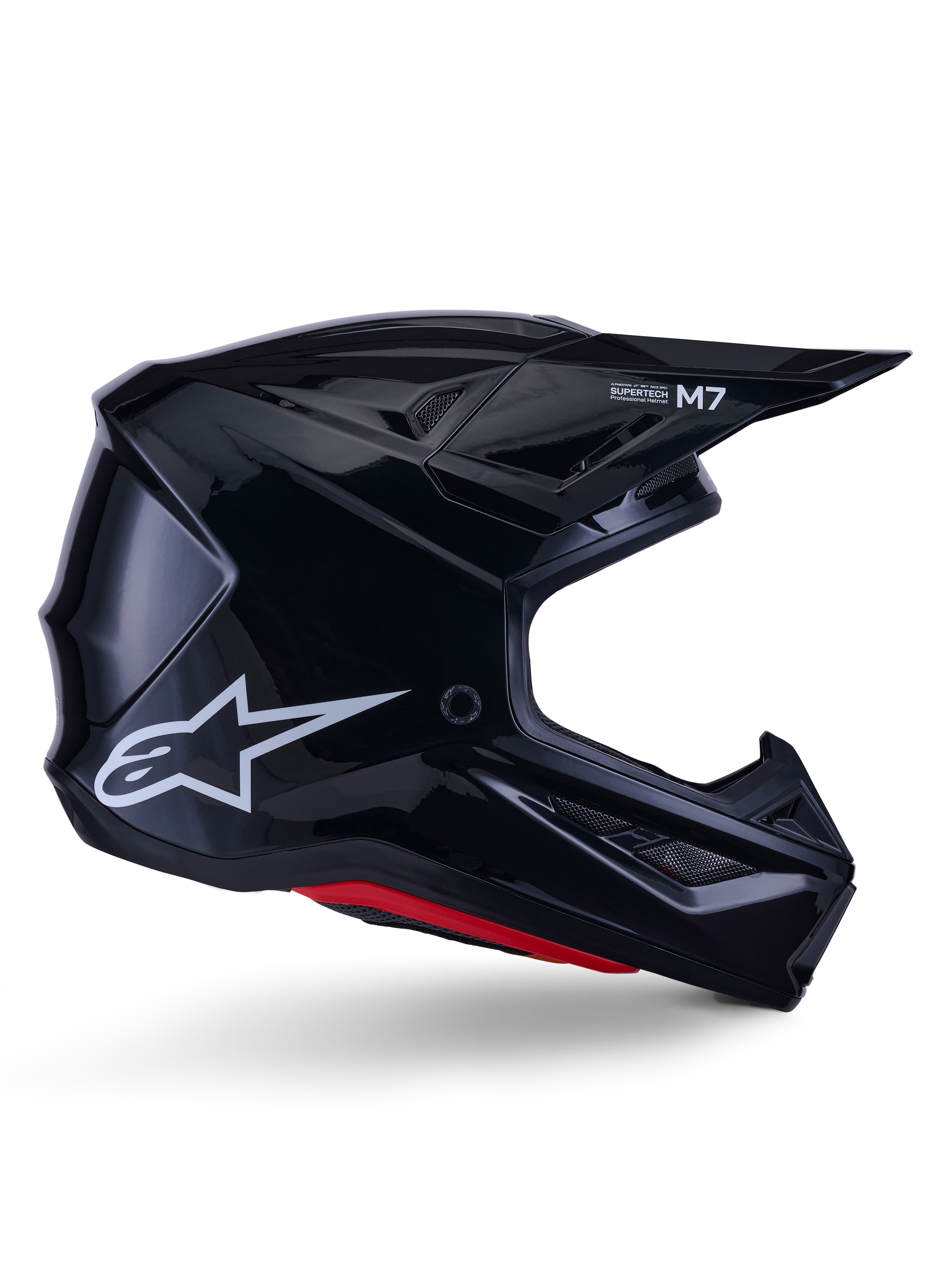 Alpinestars S-M7 Solid hjelm, motocross racinghjelm, blank sort med hvidt stjerne-logo og røde detaljer, sideprofil med aerodynamisk design, kantede ventilationsåbninger og Supertech M7-branding på visiret.