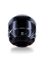 Alpinestars S-M7 Solid hjelm ECE 22.06, motocrosshjelm, blank sort, set bagfra med hvide stjernelogoer, aerodynamisk kompositskal med en højglansfinish, sikkerhedscertificering og størrelseslabels i midten